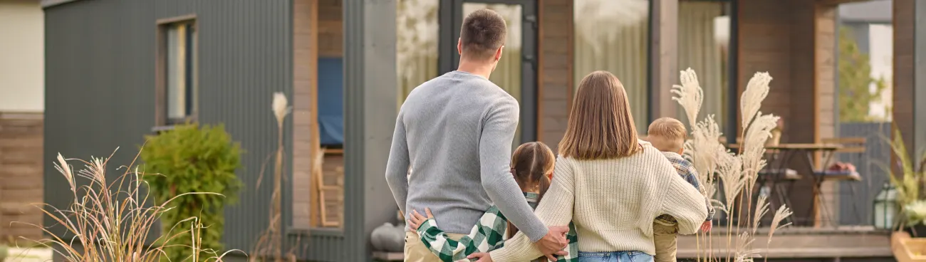 A family standing outside their home